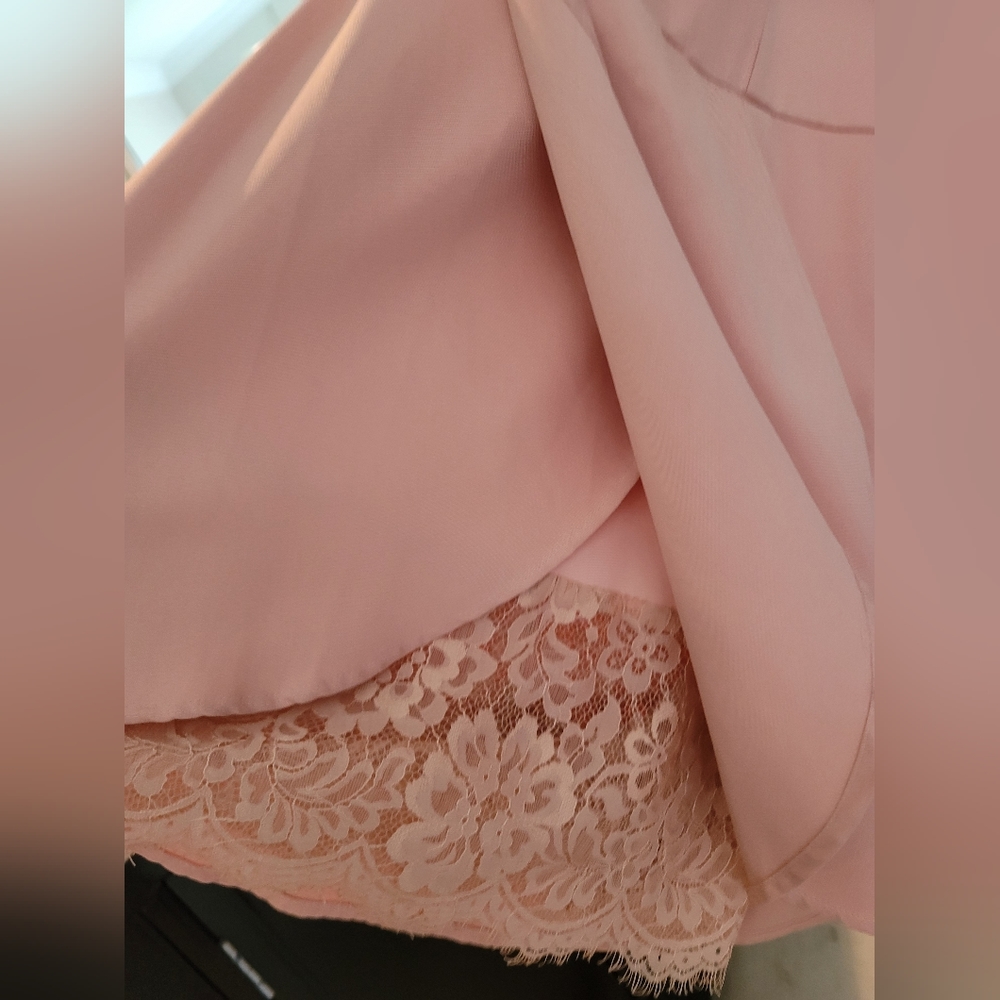Romper light peach with lace peeking at the bottom